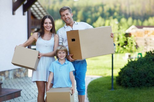 Flat removal service handling boxes and furniture in Stepney apartment building