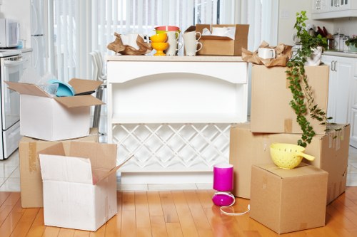 Packed moving boxes and furniture ready for transport in Stepney