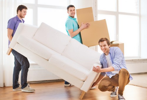 Professional movers handling office equipment during a relocation in Stepney